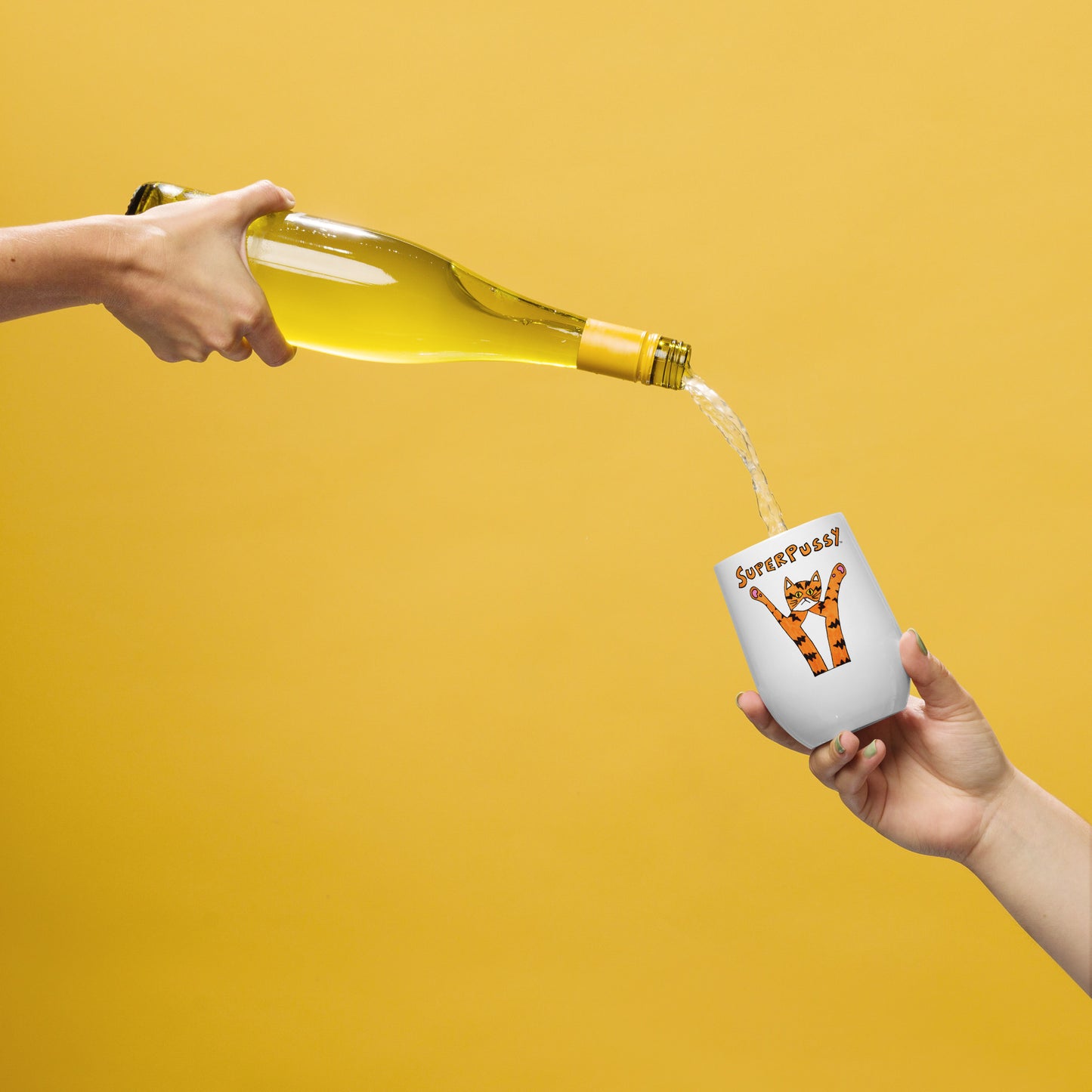 A bottle of white wine is being poured into a stainless steel wine tumbler, white, with a drawing of an orange cat with tiger stripes and his paws in the air. "Superpussy" is written in orange above it.