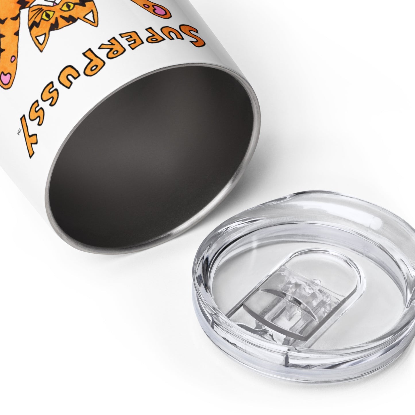 A side view that shows the travel lid laying beside A stainless steel wine tumbler, white, with a drawing of an orange cat with tiger stripes and his paws in the air. "Superpussy" is written in orange above it.