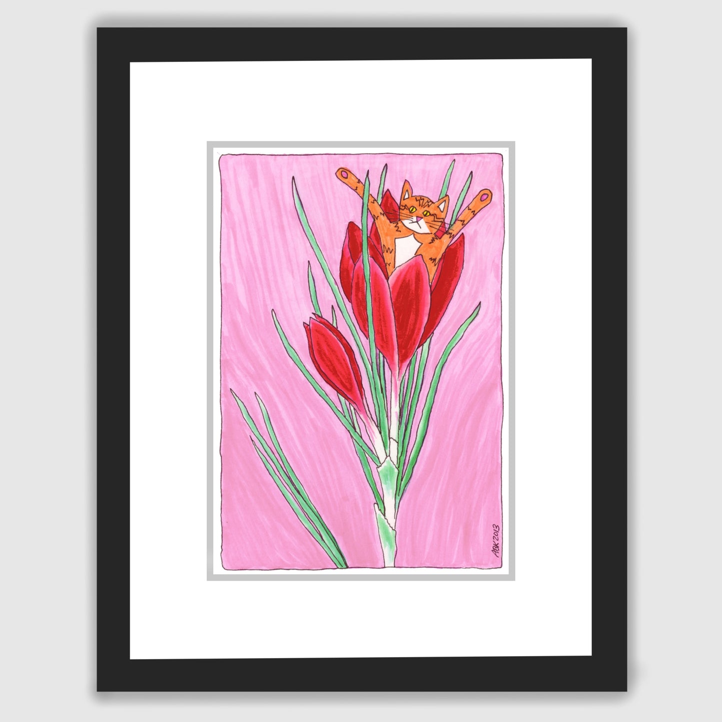 A framed print of a cat drawing featuring a fun cat hanging out in a red flower. Pink background.
